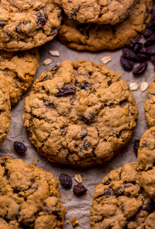 Oatmeal raisin cookies on a parchment paper lined baking sheet.