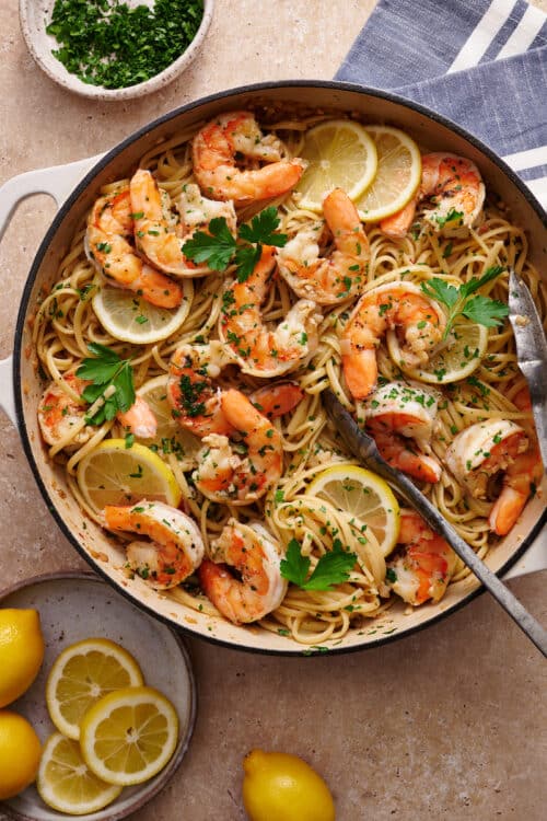 Learn how to cook shrimp scampi in 20 minutes with this easy shrimp scampi recipe! Juicy shrimp are cooked in garlic butter, white wine, and lemon juice creating the most delicious shrimp scampi sauce ever! Sprinkled with fresh parsley and red pepper flakes. We love serving this with pasta (we love linguini or angel hair), zucchini noodles, crusty bread, and dry white wine.